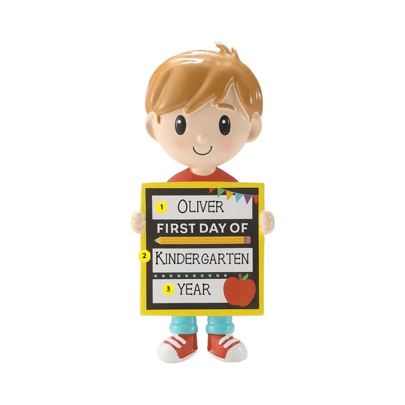 Personalized first day of school boy ornament with a name, grade, and year written on the school sign.