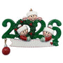 Christmas ornament with three children in hats and scarves sitting on a '2026' and a wreath.