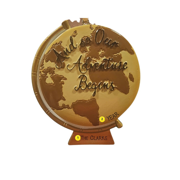 Personalized And So Our Adventure Begins globe ornament with The Clarks on the stand and year placement shown on the globe.