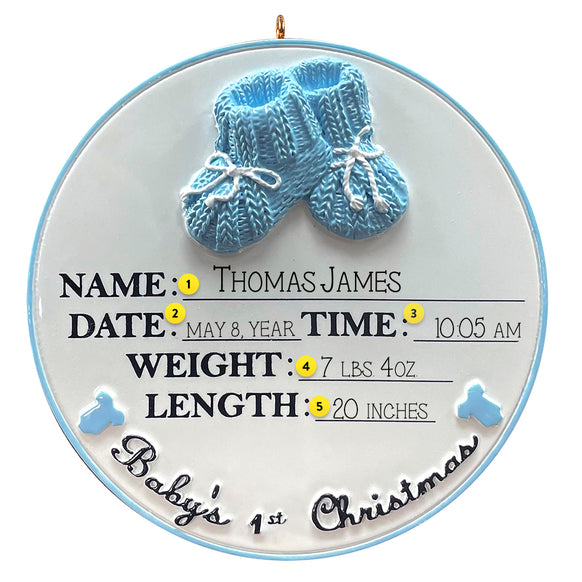 Decorative ornament with blue baby booties and newborn details on a white background
