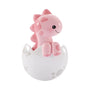 Pink baby brontosaurus ornament sitting in a white dinosaur egg shell with soft pink spots and a sweet smile.