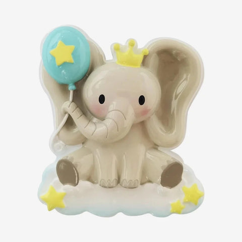 Baby elephant ornament featuring a seated elephant with oversized ears, a yellow crown, blue balloon, and star accents.