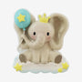 Baby elephant ornament featuring a seated elephant with oversized ears, a yellow crown, blue balloon, and star accents.