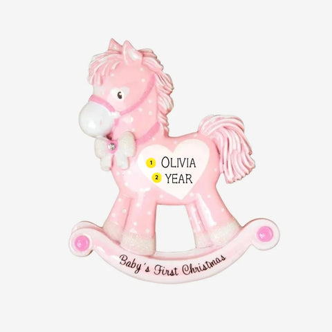 Personalized baby girl’s first Christmas pink rocking horse ornament with a name and year added to the white heart on the side.