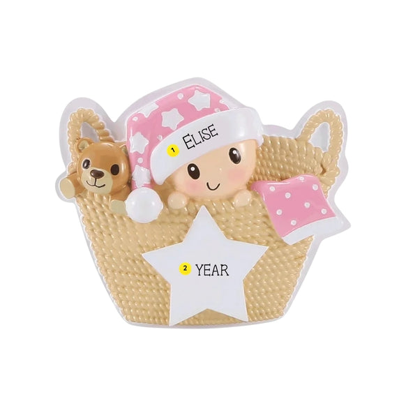 Personalized baby in a basket ornament with a name on the hat and space for a year on the white star.