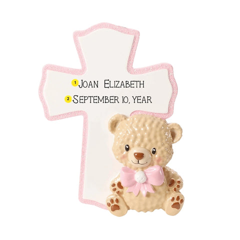 Personalized baby pink cross ornament with a child’s name and date added above a plush teddy bear with a pink bow.