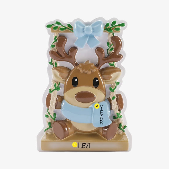 Personalized baby reindeer on swing ornament with name on the base and year placement on the blue scarf.