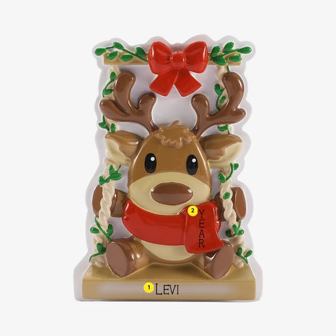 Personalized baby reindeer on swing ornament with name on the base and year placement on the red scarf.