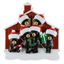 Christmas ornament with 6 black bears in front of a red barn wearing Santa hats.