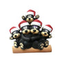 Black bear family of 5 tabletop decoration with a cuddling bear couple on a log, one cub above, and one cub on each side, all wearing Santa hats.