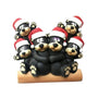 Black bear family of 6 tabletop decoration with a cuddling bear couple on a log, two cubs above, and one cub on each side, all wearing Santa hats.