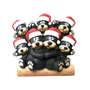 Black bear family of 7 tabletop decoration with a cuddling bear couple on a log, three cubs above, and one cub on each side, all wearing Santa hats.
