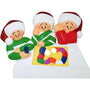 Ornament of a family with Santa hats playing a board game on a white background
