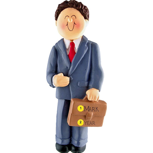 Ornament of a man in a suit holding a briefcase personalized with name and year, on a white background.