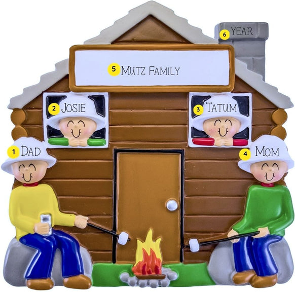 Personalized family ornament with a cabin and family members around a campfire.