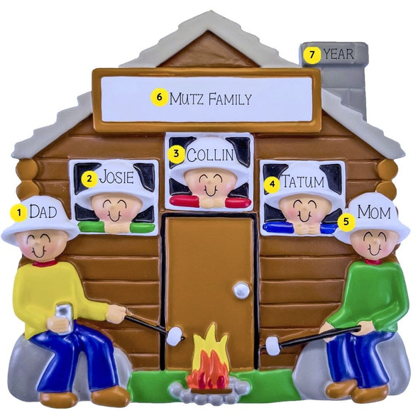 Personalized family ornament with a cabin and family members around a campfire.