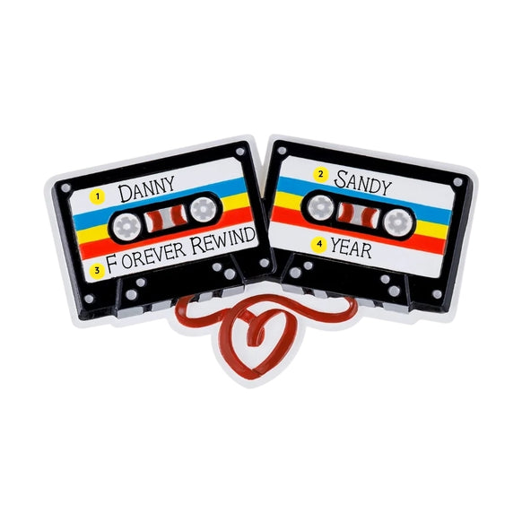 Personalized cassette couple ornament with names on the tape labels, a short phrase on one cassette, and space for a year on the other.