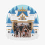 Castle photo frame ornament with blue rooftops, white towers, gold accents, and a crown detail, shown with a family theme park photo.