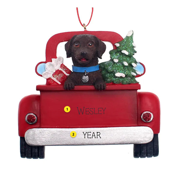 Christmas ornament of a Chocolate Labin a red truck with a tree and gift, personalized with a name and year