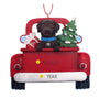Christmas ornament of a Chocolate Labin a red truck with a tree and gift, personalized with a name and year