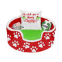 Christmas cat bed ornament with a red paw print bed, green blanket, mouse toy, catnip gift, and “We wish you a Meowy Christmas” pillow.