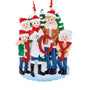 JOY family of 5 ornament with two parents and three children in winter clothes holding red glitter letters in front of snowy evergreen trees.