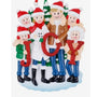 JOY family of 6 ornament with two parents and four children in winter clothes holding red glitter letters in front of snowy evergreen trees.