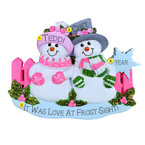 Personalized snowman couple ornament with decorative elements on a white background