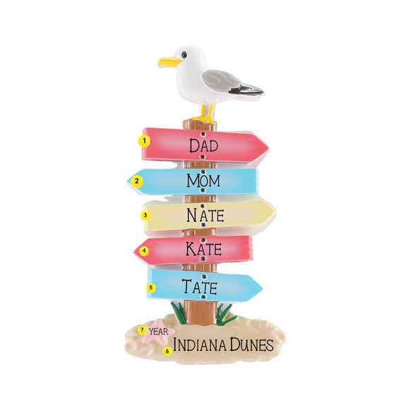 Personalized coastal sign ornament with family names on the colorful arrows, a beach destination on the sandy base, and year near the starfish.