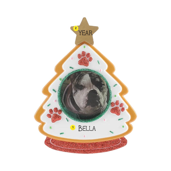 Personalized tree-shaped cookie pet picture frame ornament with a dog photo in the center, a pet name written across the bottom, and a year added on the gold star topper.
