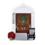 Decorative Christmas ornament of a door with a wreath, 'Welcome' sign, and potted plant on a white background.
