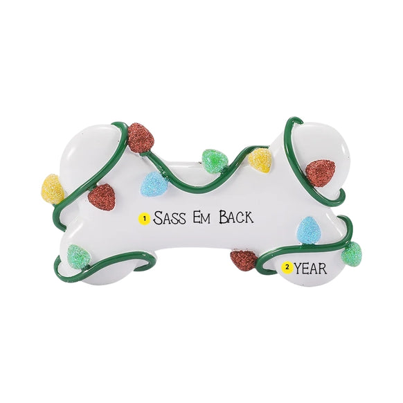 Personalized dog bone ornament wrapped in Christmas lights with a dog’s name on the bone and the year on one end.