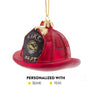 Personalized firefighter helmet glass ornament with red helmet, black fire department shield, glitter accents, gold cap, and hanging cord.
