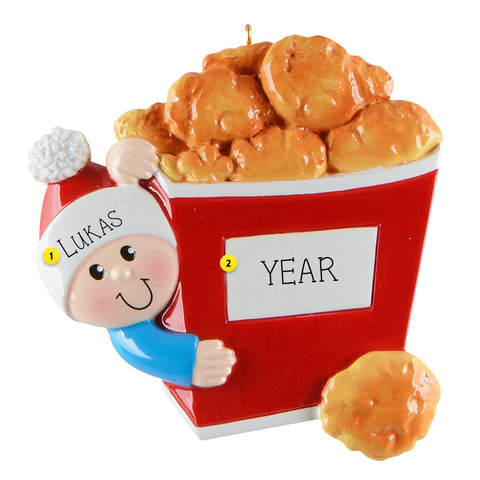 Decorative ornament with a boy holding a bucket of chicken nuggets , can be personalized with name and year