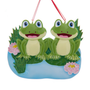 Frog pond family of two ornament with two smiling frogs, lily pads, reeds, and pink water lilies.