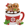 Gingerbread couple in hot cocoa mug ornament with marshmallows, holly, snowflake, and heart cookie detail.