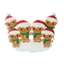 Gingerbread family of six ornament with six smiling gingerbread people in Santa hats and green scarves, gathered around a snowy base.