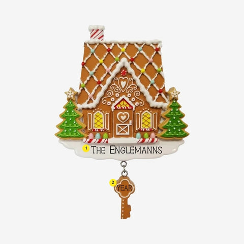 Personalized gingerbread first home ornament with family name on the snowy base and year on the dangling gingerbread key.