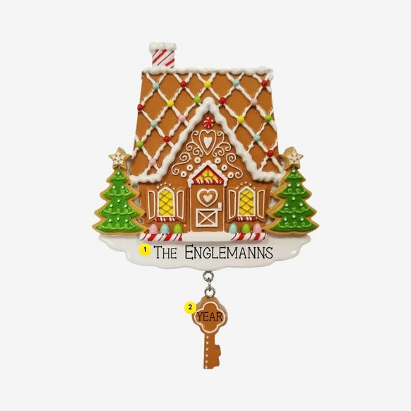 Personalized gingerbread first home ornament with family name on the snowy base and year on the dangling gingerbread key.