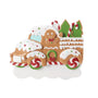 Gingerbread truck ornament with icing details, peppermint wheels, a smiling gingerbread driver, candy cane accents, and Christmas trees in the truck bed.