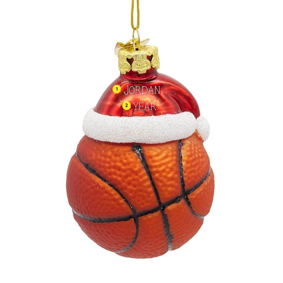 Personalized glass basketball ornament with red Santa hat, white glitter trim, gold cap, and name and year personalization guide.