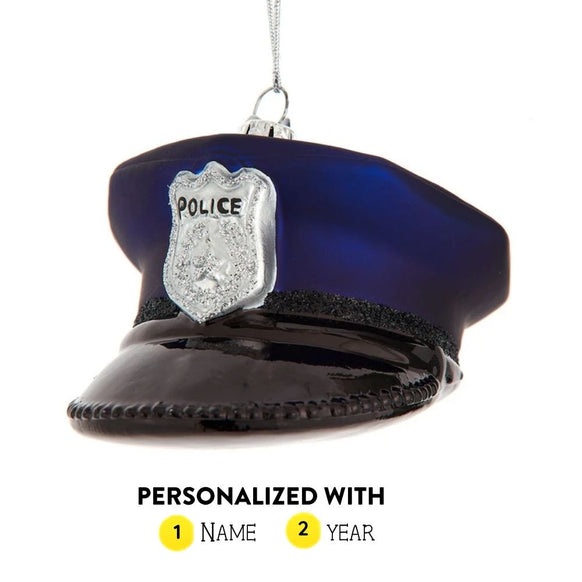 Personalized glass police hat ornament with navy blue cap, black brim, silver badge, and name and year personalization guide.