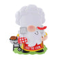 Backyard BBQ gnome ornament with a white chef hat, grill, spatula, hot dog fork, and “Kiss the Cook” apron.