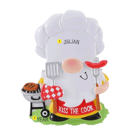 Personalized backyard BBQ gnome ornament with a name on the chef hat and space for a year on the grass by the grill.