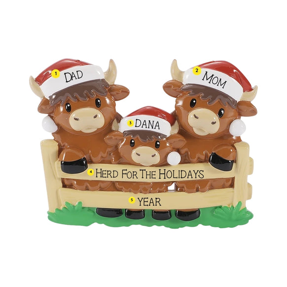 Personalized Highland cow family ornament with names on the Santa hats, a holiday phrase on the fence, and year below.