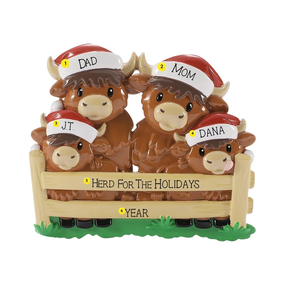 Personalized Highland cow family ornament with names on the Santa hats, a holiday phrase on the fence, and year below.