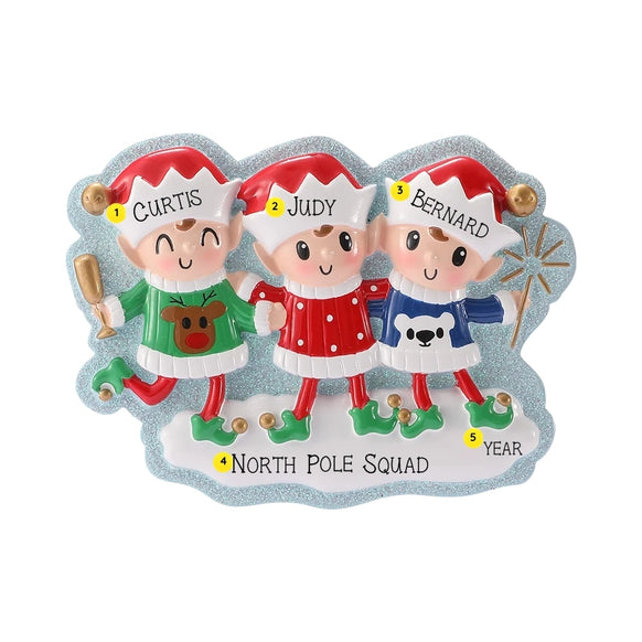 Three-elf Christmas ornament personalized with three names on the hats, a family phrase on the snowy base, and a year.
