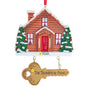 Personalization example: Personalized home with key ornament featuring a snowy brown house, decorated trees, a year on the base, and The Thompson Family on the hanging gold key.