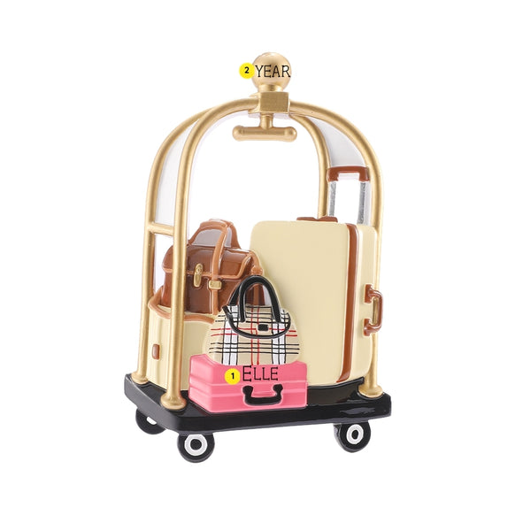 Personalized hotel luggage cart ornament with a name on the pink suitcase and year on the gold topper.