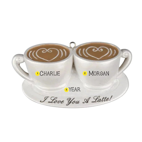 Personalized I Love You A Latte couple ornament with two white coffee cups on a saucer, names on each cup, a year between them, and heart latte art.